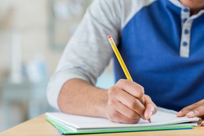Estudante escrevendo uma redação para enem e vestibular 